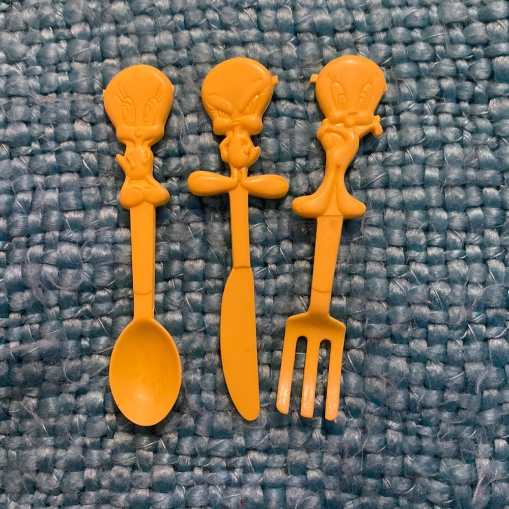 Three sets of vintage 2000 Warner brothers tweety bird play silverware.
